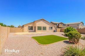 Queen Creek house for rent - a house with a gravel driveway and a yard with grass