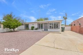 Tucson house for rent - A house with a white exterior and a grey roof is for sale.