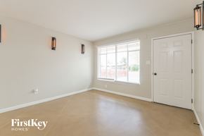 Tucson house for rent - A room with a white door and two wall sconces.