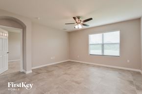 Mims house for rent - an empty room with a ceiling fan and a window