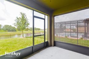 Mims house for rent - a living room with large windows and a view of a park