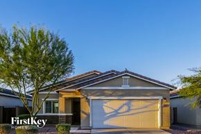 Laveen house for rent - a house with a yellow garage door and a tree