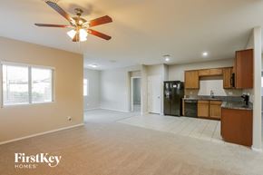 Laveen house for rent - an empty kitchen and living room with a ceiling fan
