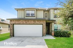San Antonio house for rent - a house with a white garage door in front of a lawn