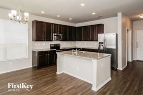 San Antonio house for rent - a kitchen with an island and a stainless steel refrigerator