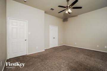 San Antonio house for rent - the living room of a home with carpet and a ceiling fan