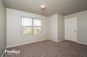 San Antonio house for rent - a bedroom with carpet and a window and a door