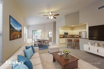 Mesa house for rent - A living room with a white couch and a painting on the wall.