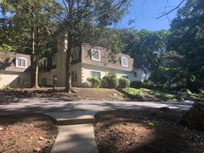 Harrisburg apartment for rent - A large house with a driveway in front of it.