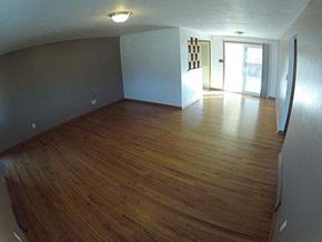 Longmont apartment for rent - A room with wooden floors and white walls.