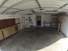 Longmont apartment for rent - A spacious garage with a concrete floor and a white ceiling.
