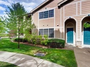 Lafayette apartment for rent - A beige building with a blue door and a tree in front.