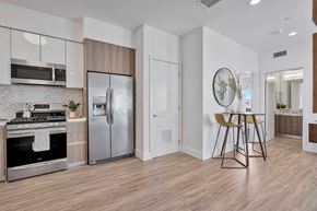 Los Angeles apartment for rent - an open kitchen and dining room with a stainless steel refrigerator