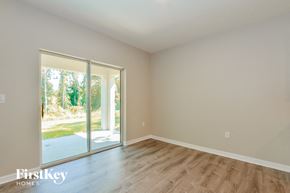 Leesburg house for rent - A room with a sliding glass door leading to a backyard.