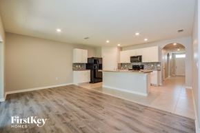 Leesburg house for rent - A spacious kitchen with a refrigerator, microwave, and oven.