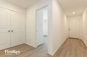 Converse house for rent - a bedroom with two closets and a door to a hallway