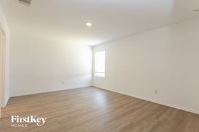 Converse house for rent - the living room of a home with white walls and wood floors