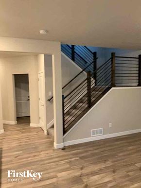 Colorado Springs house for rent - a view of a staircase in a home with wood floors and white walls