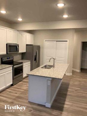Colorado Springs house for rent - an empty kitchen with a counter top and a sink