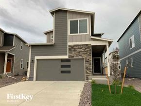 Colorado Springs house for rent - a house with a garage and a driveway in front of it