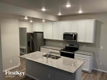 Colorado Springs house for rent - an updated kitchen with white cabinets and granite counter tops