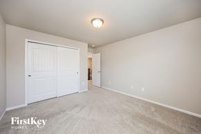 Colorado Springs house for rent - a bedroom with a closet and a door to a hallway