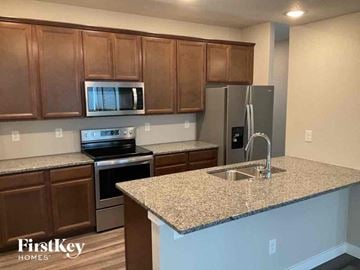 Colorado Springs house for rent - a kitchen with granite counter tops and stainless steel appliances