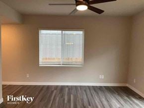 Colorado Springs house for rent - a living room with a window and a ceiling fan