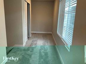 Colorado Springs house for rent - a empty room with a green carpet and a window