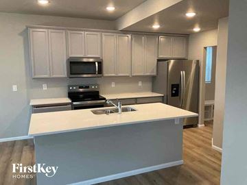 Colorado Springs house for rent - an updated kitchen with white cabinets and a white counter top