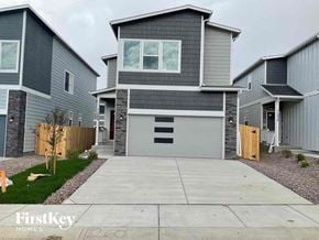 Colorado Springs house for rent - a gray house with a gray garage door and a cement driveway