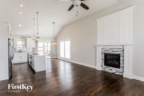Parkville house for rent - an open kitchen and living room with a fireplace