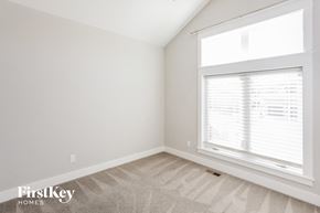 Parkville house for rent - a bedroom with a large window and white walls