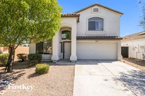 San Tan Valley house for rent - A white house with a brown roof and a tree in front.