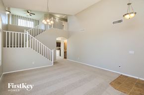 San Tan Valley house for rent - A spacious living room with a staircase and a chandelier.
