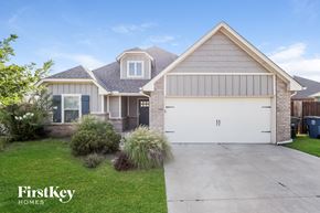 Edmond house for rent - a house with a white garage door and a driveway in front of it