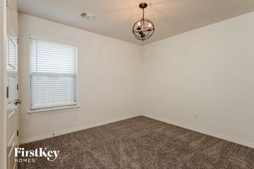 Edmond house for rent - the living room of a home with carpet and a chandelier