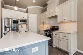 Edmond house for rent - a kitchen with white cabinets and a white counter top