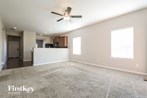Thornton house for rent - an empty living room with a ceiling fan and a kitchen