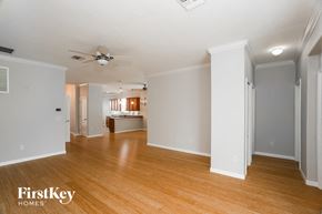 North Port house for rent - an empty living room with wood flooring and a ceiling fan