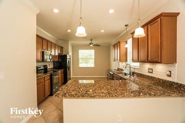 North Port house for rent - a kitchen with granite counter tops and wooden cabinets
