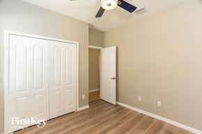 North Port house for rent - a bedroom with a closet and a ceiling fan