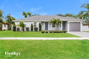 Orlando house for rent - A house with a grey roof and a white garage door is for sale.