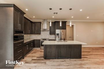 Orlando house for rent - A modern kitchen with dark wood cabinets and a central island.