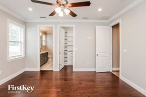 Orlando house for rent - A room with a ceiling fan and wooden floors.