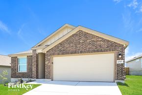 San Antonio house for rent - a house with a garage door and a lawn
