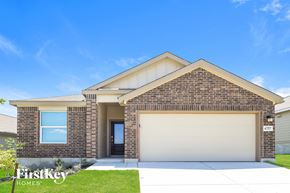 San Antonio house for rent - a house with a garage door and a lawn