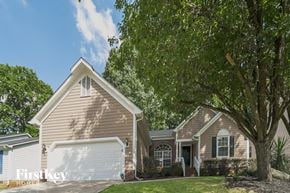 Charlotte house for rent - a house with a garage and a tree in front of it