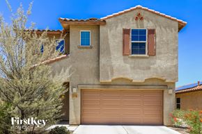 Tucson house for rent - A house with a brown garage door is for sale.