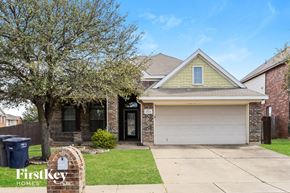 Fort Worth house for rent - A house with a garage and a tree in front of it.